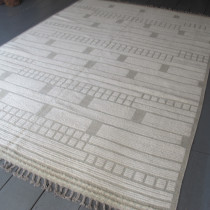 Contemporary Modernist Carpet - This stylish contemporary wool carpet was woven by Afghan weavers. Using mixed techniques to create texture and the two tone colouring in shades of ivory and pale green give this carpet a subtle ambience, very much in line with current taste. The geometric design adds to the sense of modernity. Fine quality wool has been used. This is a very decorative carpet that would work well in any number of contemporary settings. Image of Contemporary Modernist Carpet