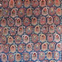 Khamseh Rug with Botehs - Probably initially woven for domestic use, this lovely tribal rug has all the hallmarks of the best Khamseh weavings. The quality is fine, with soft handspun wool and dyes derived from natural sources. The kilim ends and barber pole selvages are intact. The ubiquitous repeating boteh pattern in the field is beautifully drawn with each row of botehs turning in opposite directions. The spaces between the botehs is filled with myriad scattered ornaments, a sure sign of the expressiveness and independence of the weaver, which gives the rug a feeling of spontaneity. Note too the lovely terracotta border filled with equally charming botehs and other scattered floral ornaments. The entire composition is highly attractive. This accomplished rug is both collectible and decorative and has the added merit of being in excellent condition. Image of Khamseh Rug with Botehs