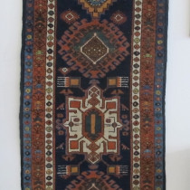 North-West Persian Runner - This handsome wool runner was probably woven by Shahsavan tribal weavers in the Azerbaijan region of North-West Persia in the last quarter of the 19th century. It has cotton warps with a mixture of cotton and wool wefts which is often an indication of the transition phase from a purely nomadic weaving environment to a village environment. Nevertheless, it retains a strong tribal character. A row of archaically drawn geometric medallions on a beautiful sapphire field are framed by three narrow stylised floral borders in ivory, terracotta and light blue. Note the birds surrounding the ivory and bottom green medallions. It is a striking composition which feels both archaic and elegant at the same time. In excellent condition with good even pile throughout. Original selvages and ends are intact. Image of North-West Persian Runner
